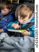 Boy in car with a digital device