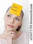 Young woman with sticky note