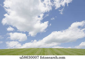 Cumulus clouds over hill
