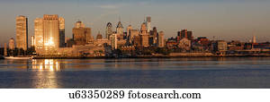 The skyscrapers of Philadelphia rise above the Delaware River at sunrise