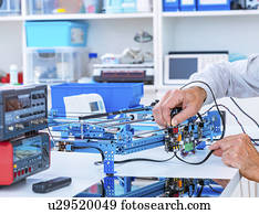 Person working in electronics laboratory.