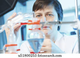 Woman doing experiment in chemical laboratory