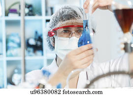 Woman doing experiment in chemical laboratory