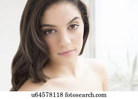 Woman with brown hair looking at camera