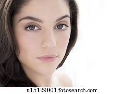 Woman with brown hair looking at camera