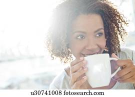 Mid adult woman drinking coffee