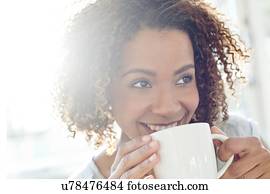 Mid adult woman drinking coffee