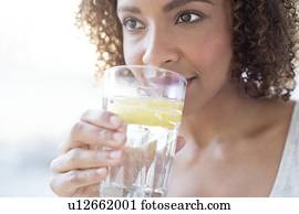 Mid adult woman drinking water