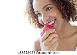 Mid adult woman eating apple