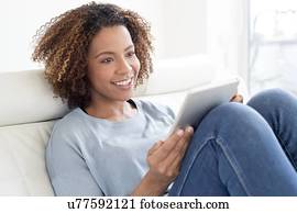 Mid adult woman using tablet