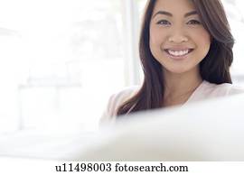 Woman with brown hair smiling towards camera