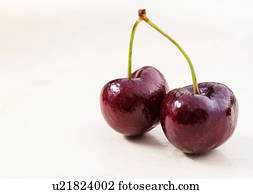 Shiny cherries on white background