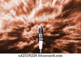 Spark plug receiving power and energy in a symbolic dark red sky.