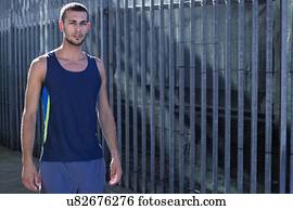 Young man in blue vest, portrait.