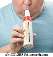 Overweight man using a peak flow metre.
