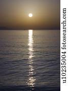 Sunset over calm sea.