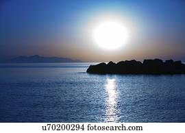 Sunset over calm sea.