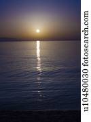 Sunset over calm sea.