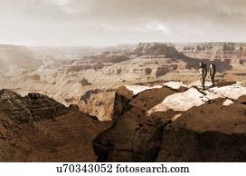 Illustration of the Valles Marineris canyon system, Mars, being surveyed by a pair of astronauts. The Valles Marineris is over 4000 kilometres (km) long, up to 200 km wide and up to 7 km deep, dwarfing the Grand Canyon of Arizona, USA. The canyons are...