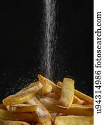 Salt pouring onto chips.