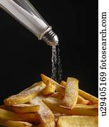 Salt pouring onto chips.