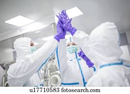 técnicos laboratório, em, um, ambiente estéril, high-fiving.