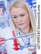 Laboratory assistant with chemical experiment.