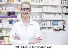 Portrait of smiling female pharmacist standing in pharmacy.