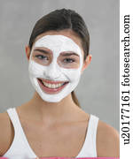 Laughing woman with curd mask