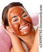 Young woman with chocolate mask
