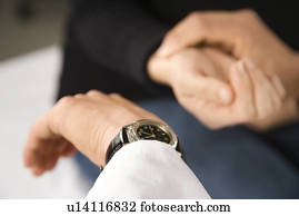 Doctor taking patient's pulse.