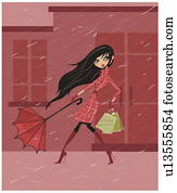 Woman holding onto her umbrella in a rainstorm Woman holding onto her umbrella in a rainstorm