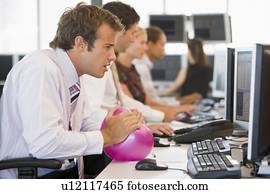 Businessman in office space with a ball
