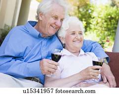 https://cdn-grid.fotosearch.com/UNP/UNP171/senior-couple-sitting-outdoors-having-a-picture__u15341957.jpg