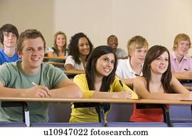 Students in class paying attention and taking notes (depth of field)