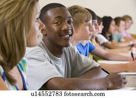 Students in class paying attention and taking notes (selective focus)