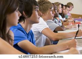 Students in class paying attention and taking notes (selective focus)