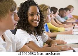 Students in class paying attention and taking notes (selective focus)