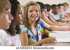 Students in class paying attention and taking notes (selective focus)