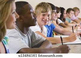 Students in class paying attention and taking notes (selective focus)