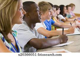 Students in class paying attention and taking notes (selective focus)
