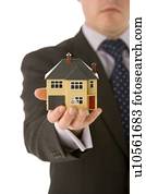 Businessman Holding Small House 