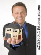 Businessman Holding Small House 