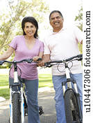 Senior Couple Riding Bikes In Park