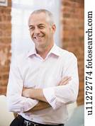 Businessman sitting in office space smiling