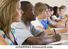 Students in class paying attention and taking notes (selective focus)