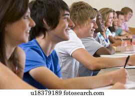 Students in class paying attention and taking notes (selective focus)