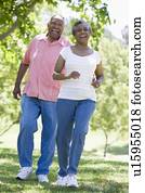 Senior couple walking in park together Senior couple walking in park together