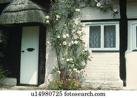 Dormer Window Above Porch On White Country Cottage Stock Photo