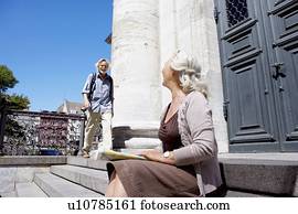 Woman looking over at man